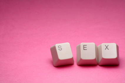 Keys from a computer keyboard spelling out the word "sex" on a pink background